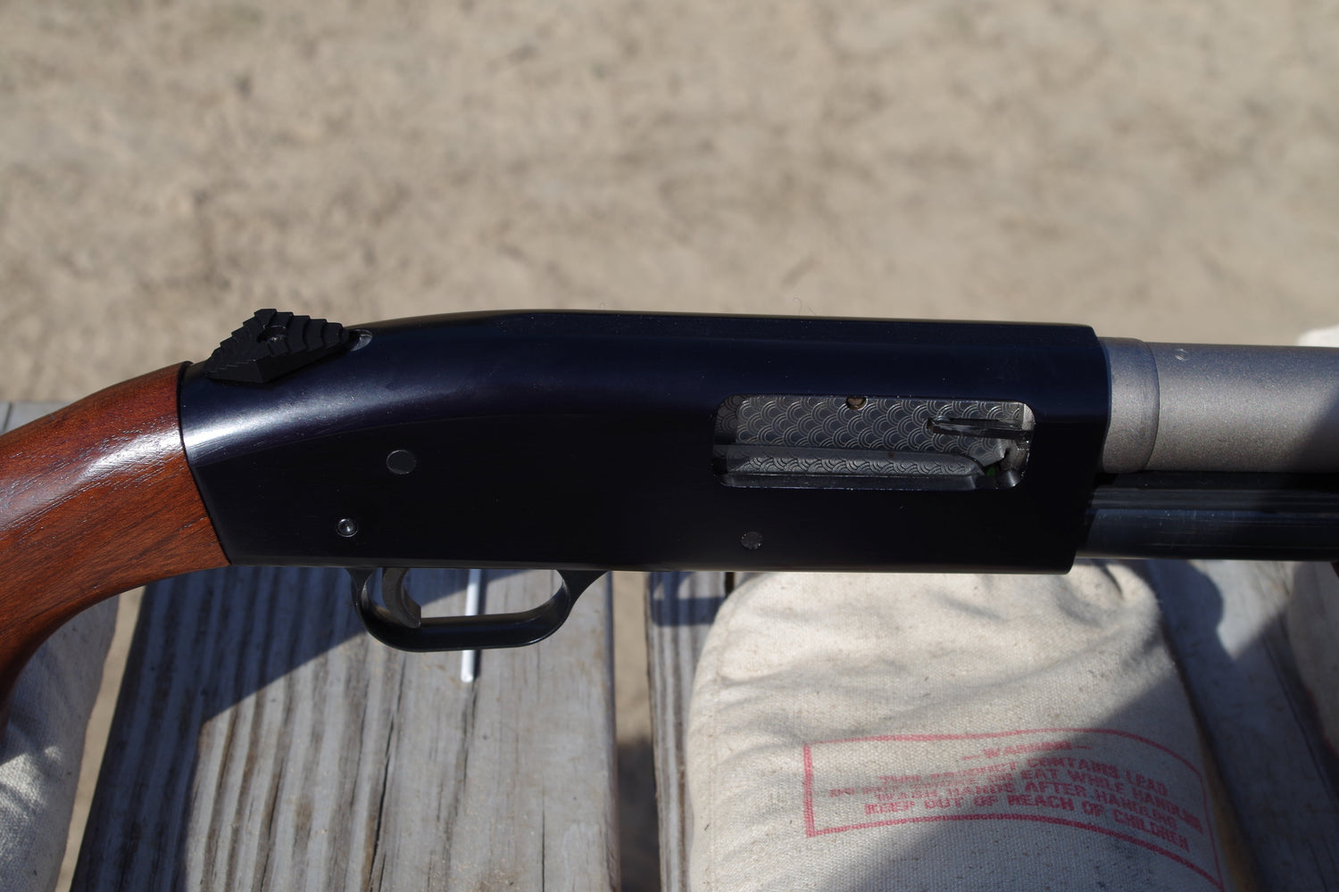 Mossberg 500 with nickel barrel and oversize safety.